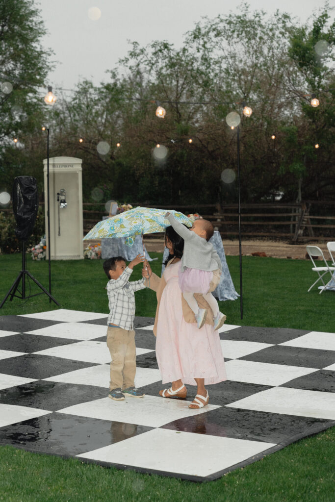 Couple dancing on outdoor checkered floor at The Cottage at River Bend in Eagle, Idaho.