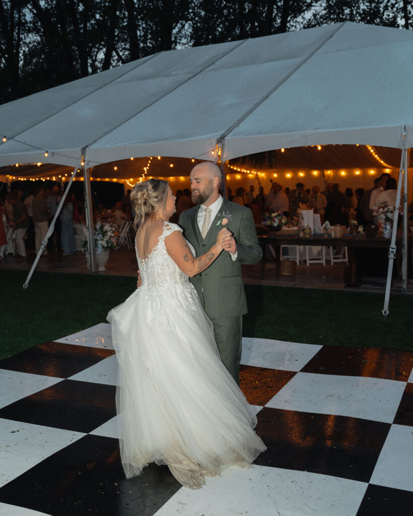 Couple dancing on outdoor checkered floor at The Cottage at River Bend in Eagle, Idaho.