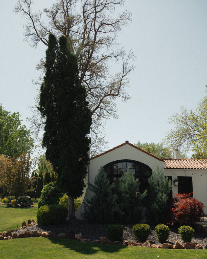 Exterior of The Cottage at River Bend in Eagle, Idaho with stucco walls and red tile roof.